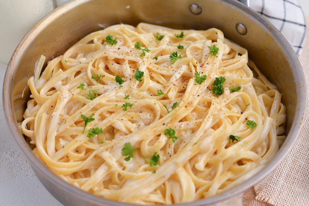 fettucine pasta with alfredo sauce in a pan