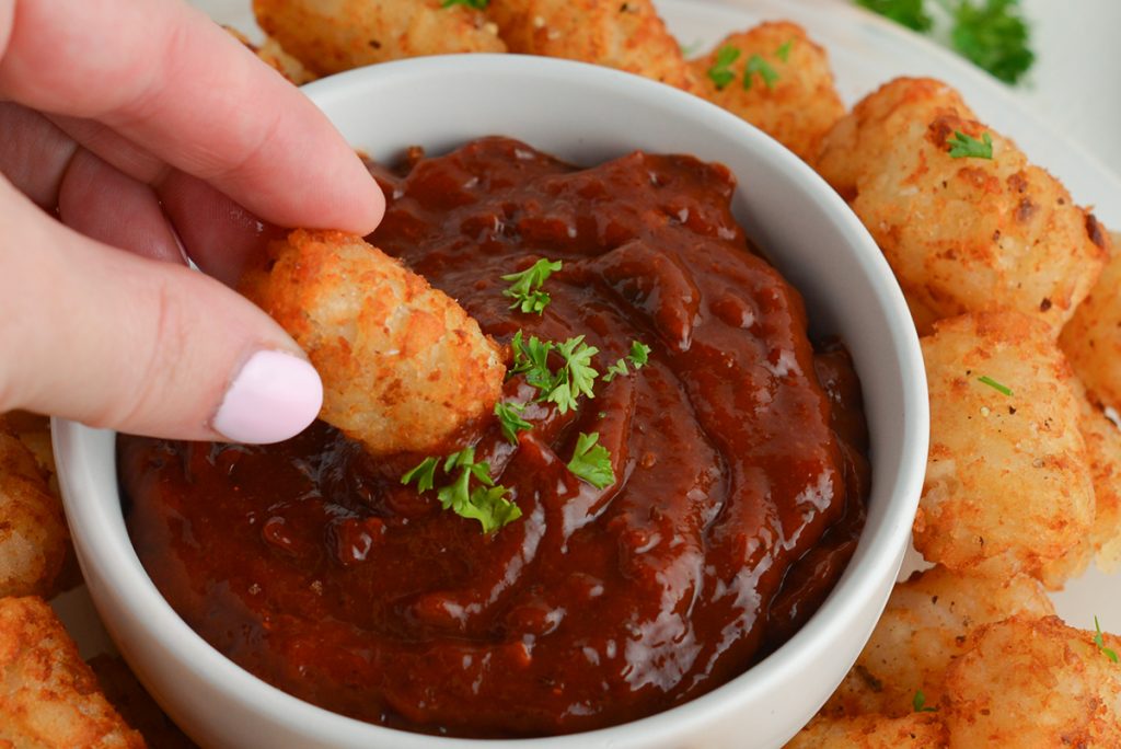 tater tot dipped into chipotle ketchup