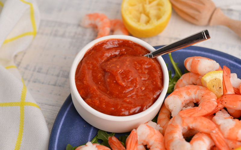 bowl of cocktail sauce with a spoon