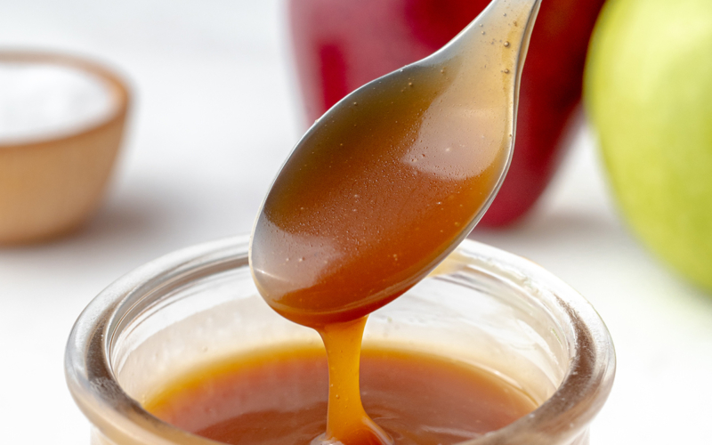 salted caramel sauce dripping off of spoon