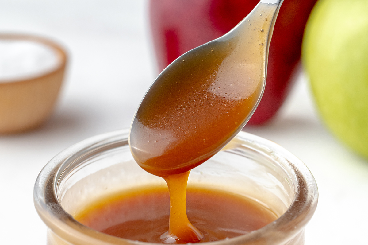 salted caramel sauce dripping off of spoon