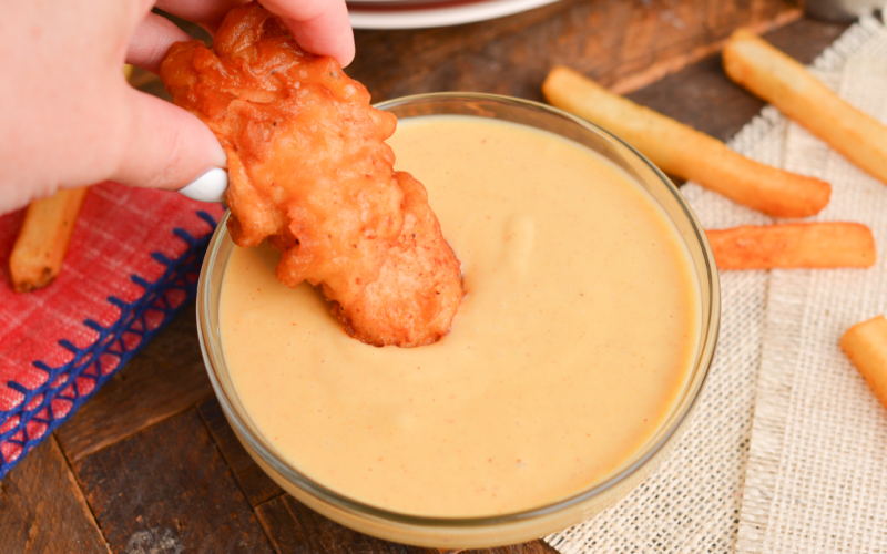 chicken dipping into chilis honey mustard sauce