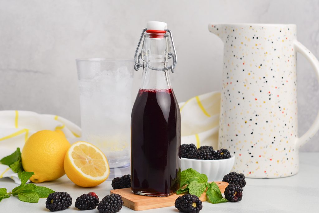 straight on shot of bottle of blackberry simple syrup
