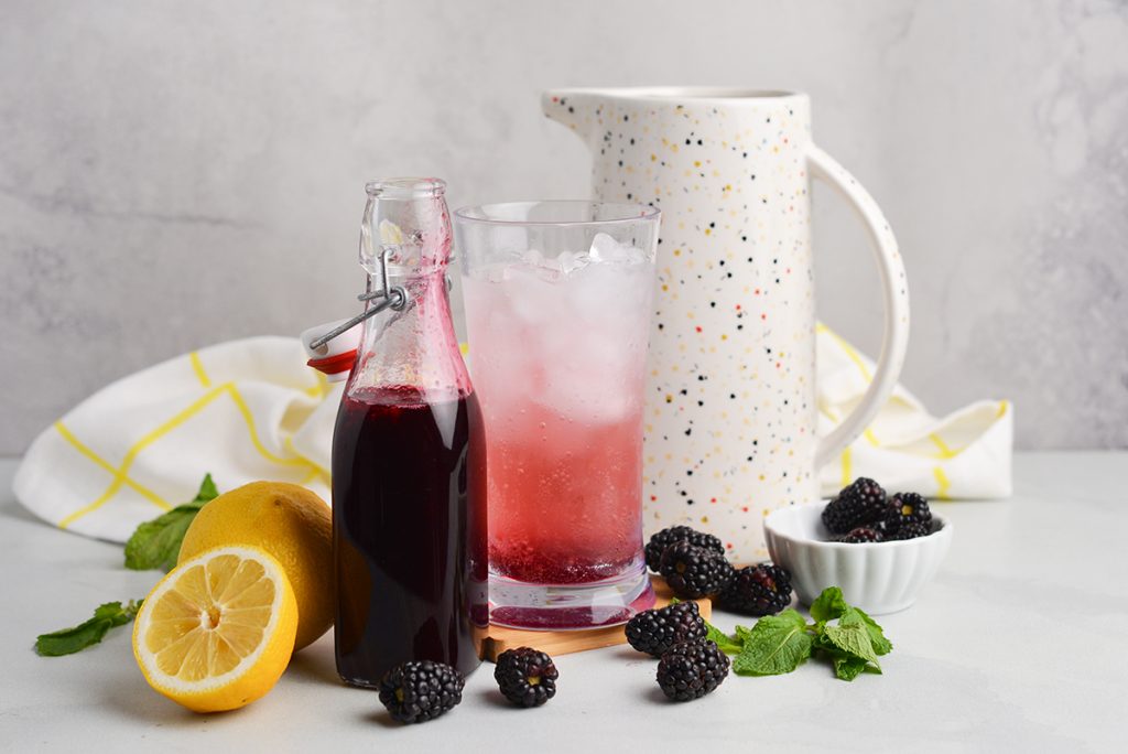 blackberry syrup with cocktail and pitcher