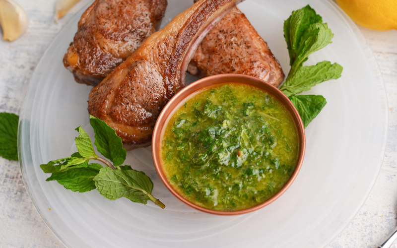 bowl of mint sauce with lamb chops