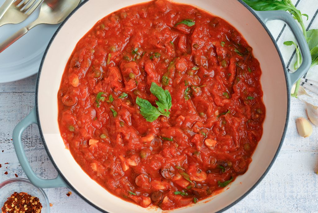 close up of puttanesca sauce in a pot