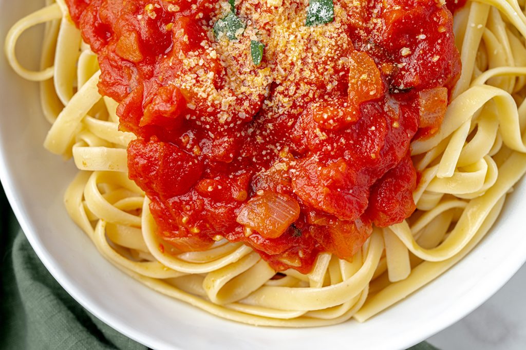 close up of spicy marinara sauce on pasta