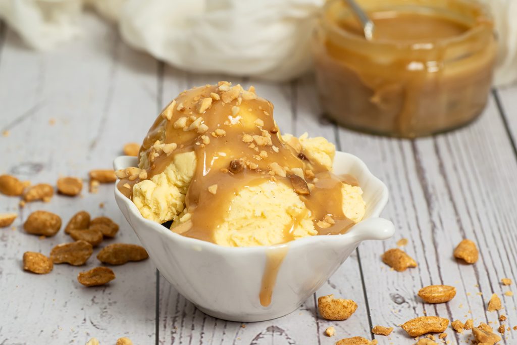 ice cream topped with nuts and sauce