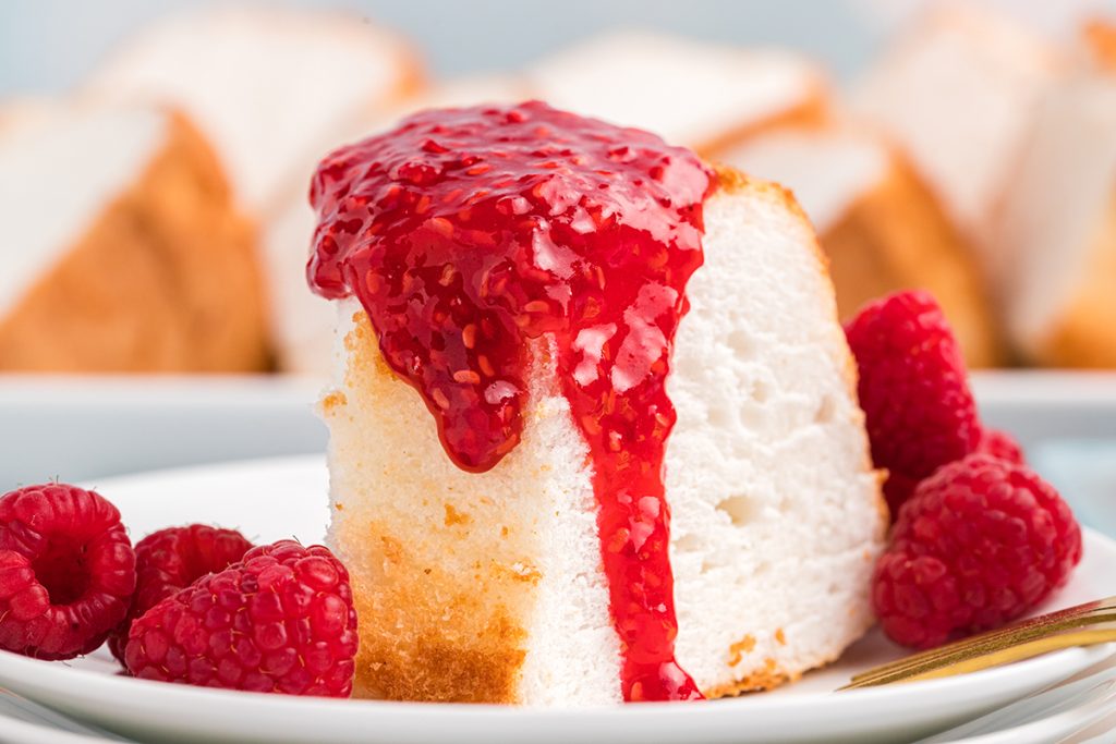 close up of angel food cake with raspberry topping
