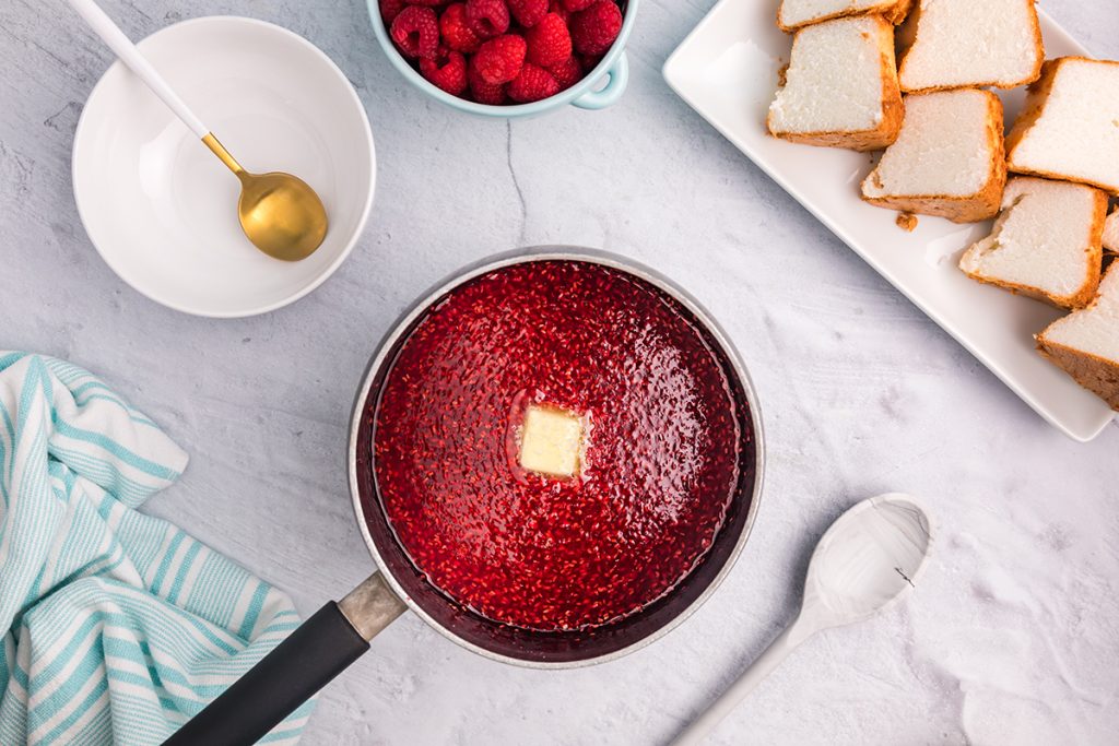 overhead sauce of raspberry topping in pan