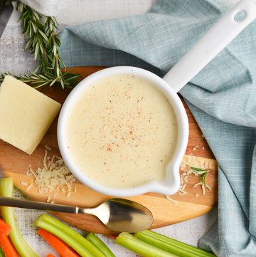 overhead shot of cream sauce with parmesan and veggies