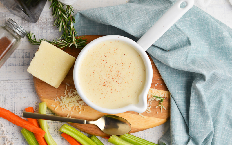 overhead shot of cream sauce with parmesan and veggies