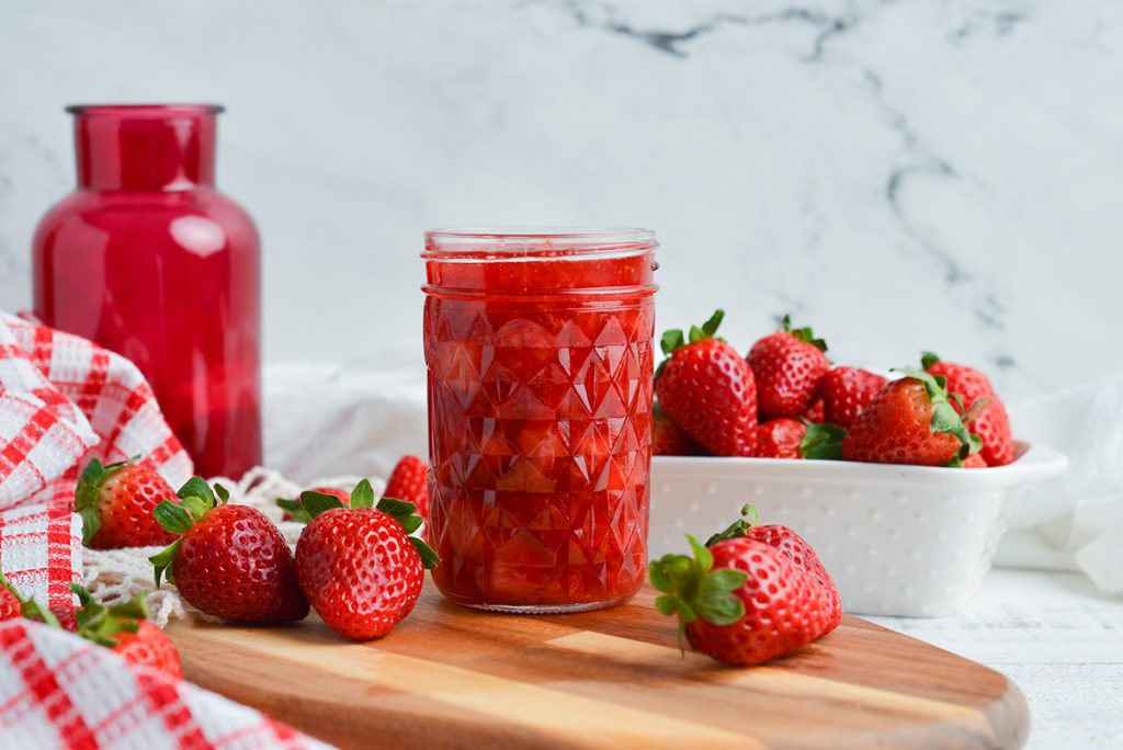 straight on shot of jar of fresh strawberry sauce