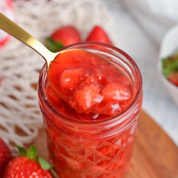 spoon in jar of strawberry topping