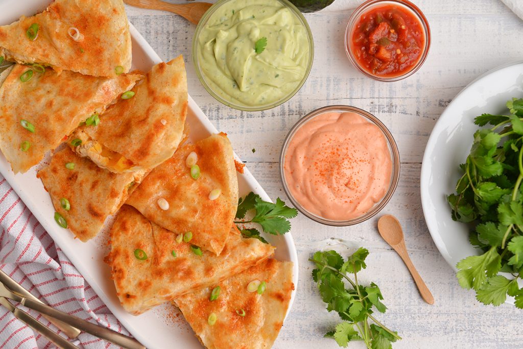 overhead shot of quesadillas with three sauces