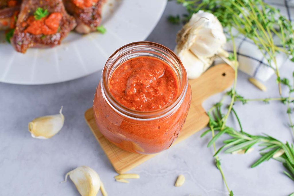 angled shot of romesco sauce in jar