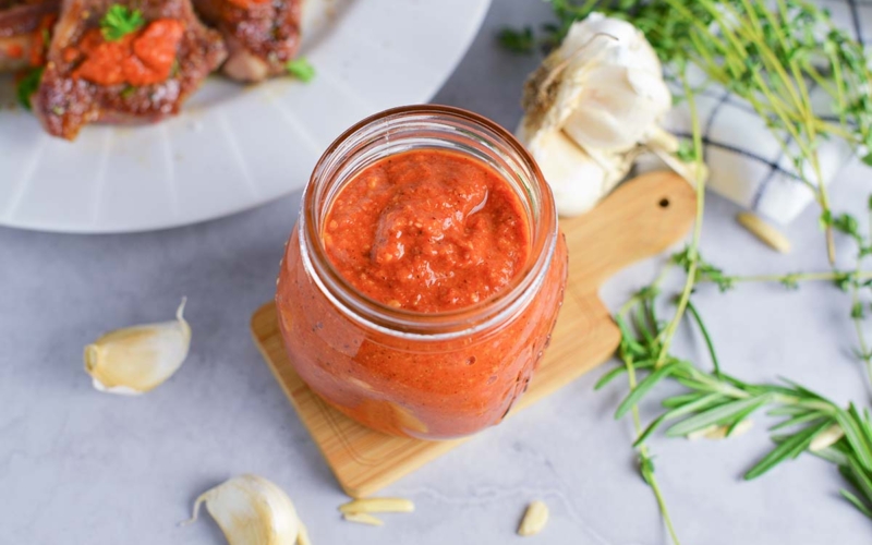 angled shot of romesco sauce in jar