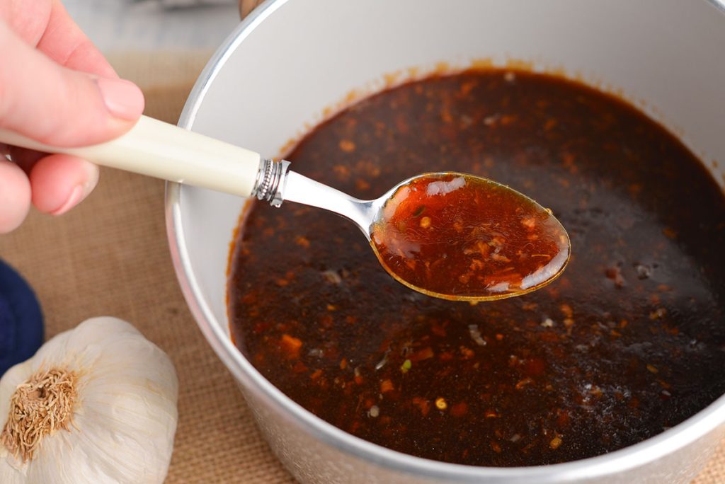 spoon in pan of chinese garlic sauce