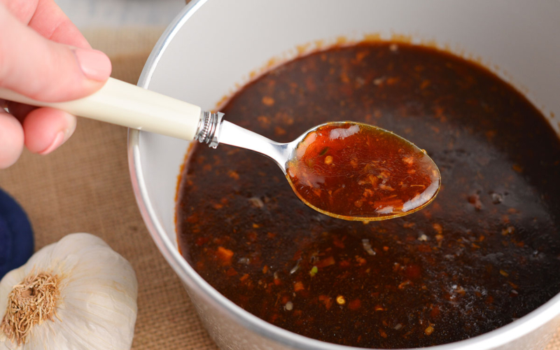 spoon in pan of chinese garlic sauce