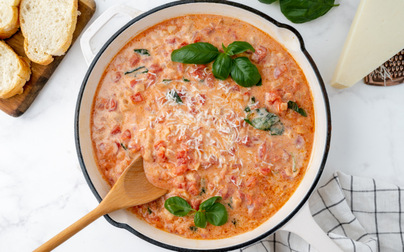 overhead shot of wooden spoon in pan of vodka cream sauce