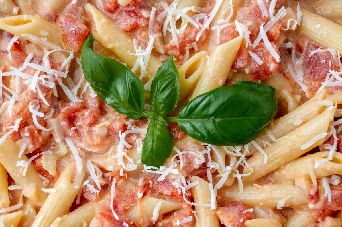 basil leaves in bowl of pasta