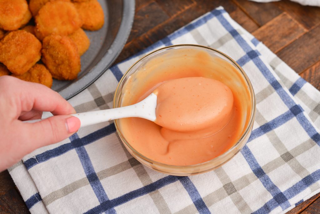 spoon in bowl of chicken nugget dipping sauce