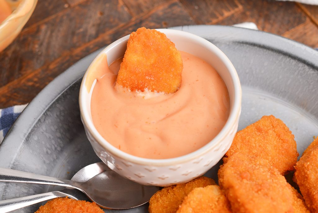 chicken nugget in bowl of sauce