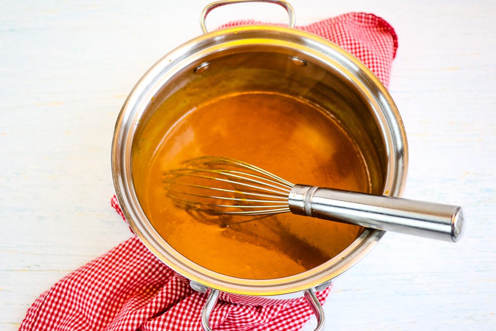 whisk in pan with sauce