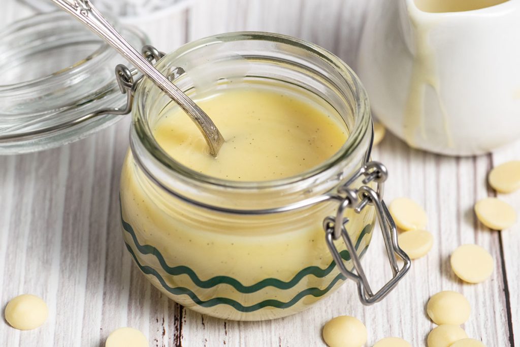 spoon in jar of white chocolate sauce