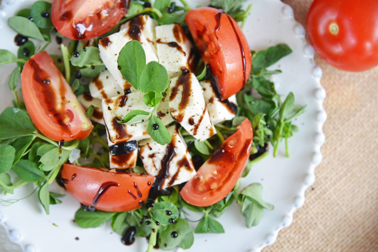 overhead shot of salad drizzled with balsamic reduction