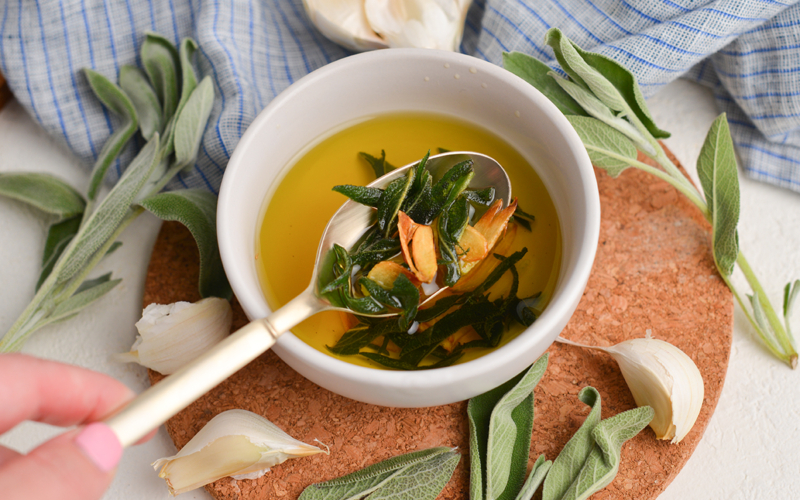 spoon in bowl of brown butter sage sauce