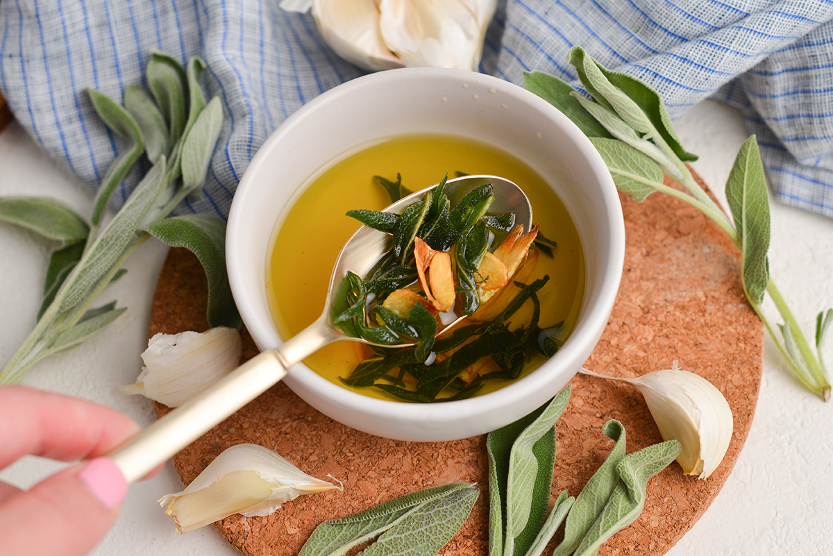 spoon in bowl of brown butter sage sauce