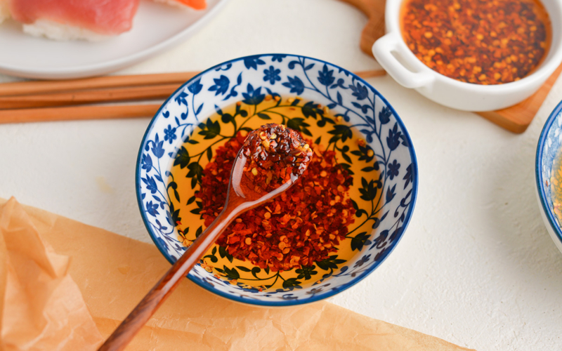 angled shot of spoon in bowl of chili oil