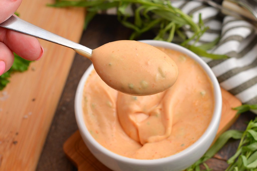 close up of spoon full of french choron sauce