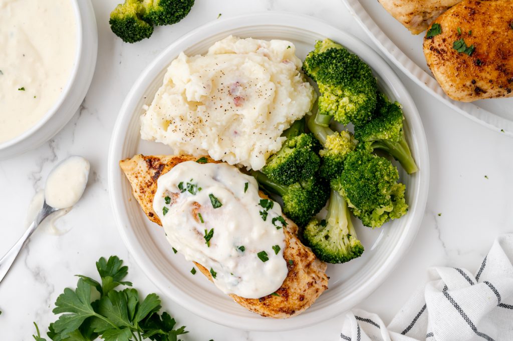 overhead shot of plate of chicken, potatoes and broccoli