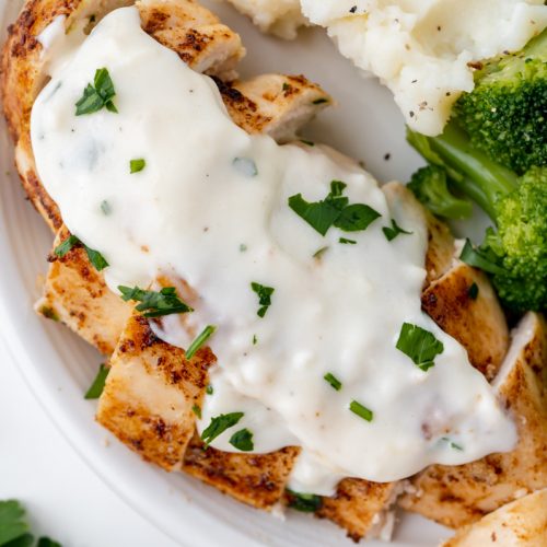overhead shot of chicken topped with cream sauce