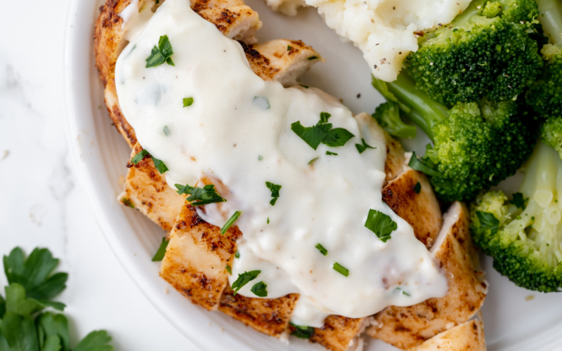 overhead shot of chicken topped with cream sauce