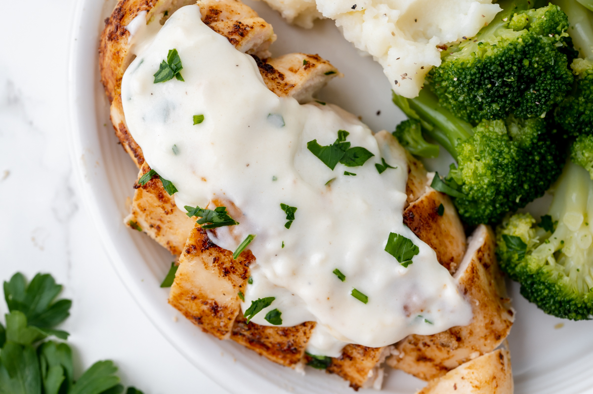 overhead shot of chicken topped with cream sauce