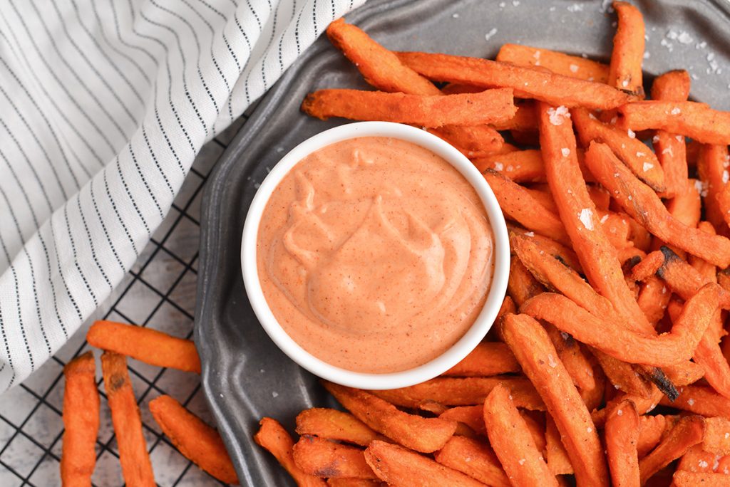 overhead shot of bowl of sweet potato fry dipping sauce with sweet potato fries