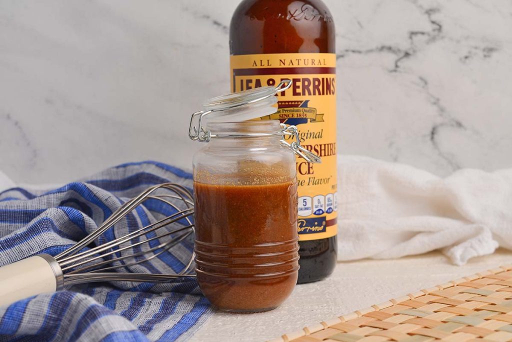 jar of homemade worcestershire sauce with whisk