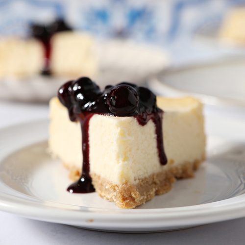 slice of cheesecake topped with blueberry sauce