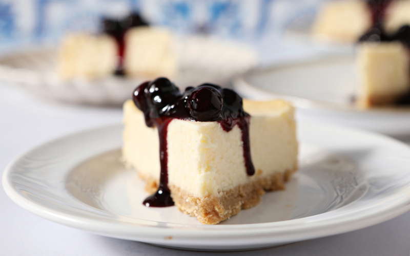 slice of cheesecake topped with blueberry sauce