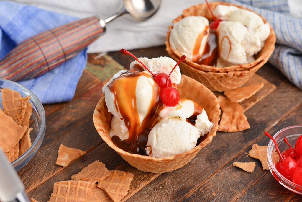 angled shot of two butterscotch sundaes