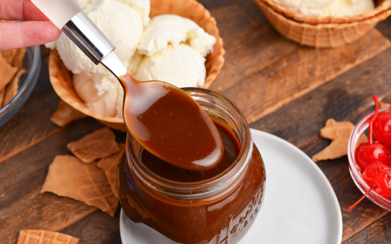 angled shot of spoon dipping into butterscotch sauce