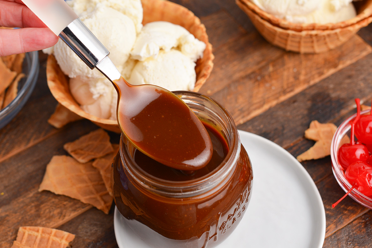 angled shot of spoon dipping into butterscotch sauce