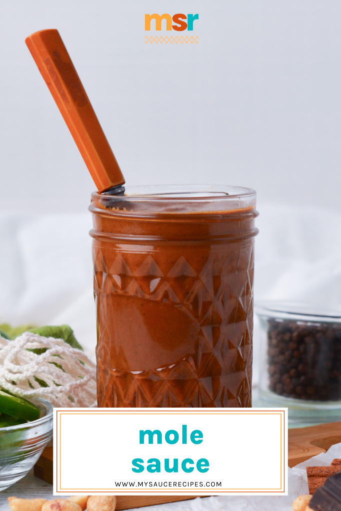 straight on shot of spoon in jar of mole sauce with text overlay for pinterest