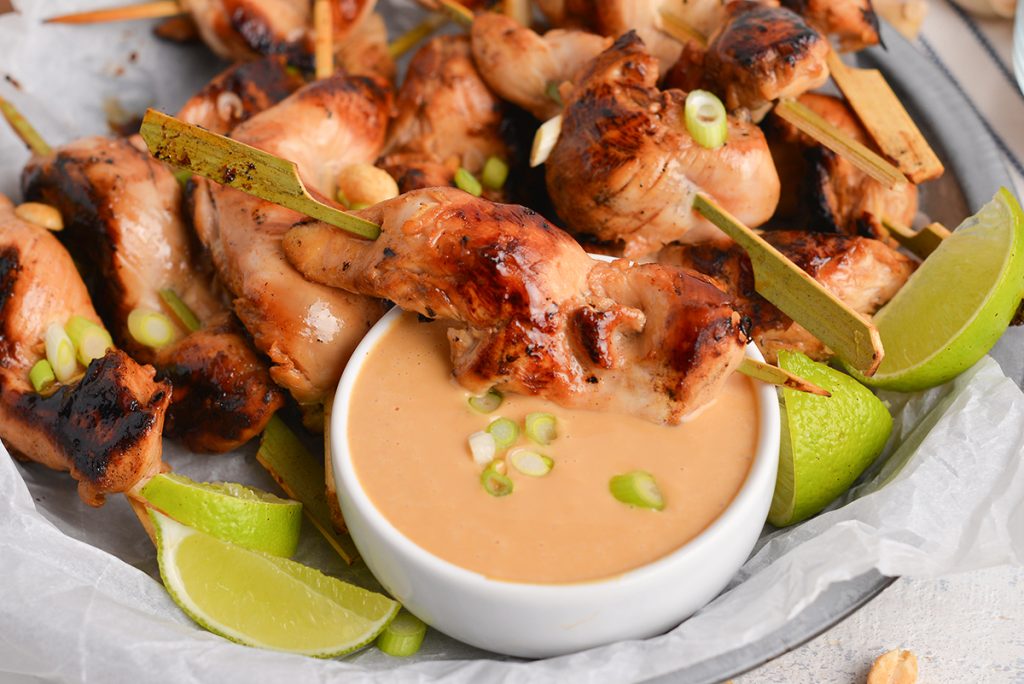 chicken skewer dipped into creamy sauce