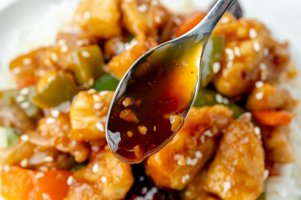 close up of spoon full of szechuan sauce