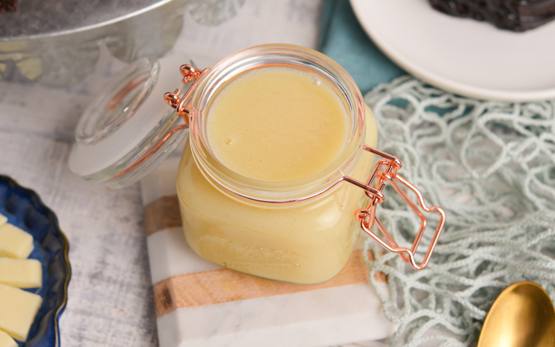 close up angled shot of jar of white chocolate sauce