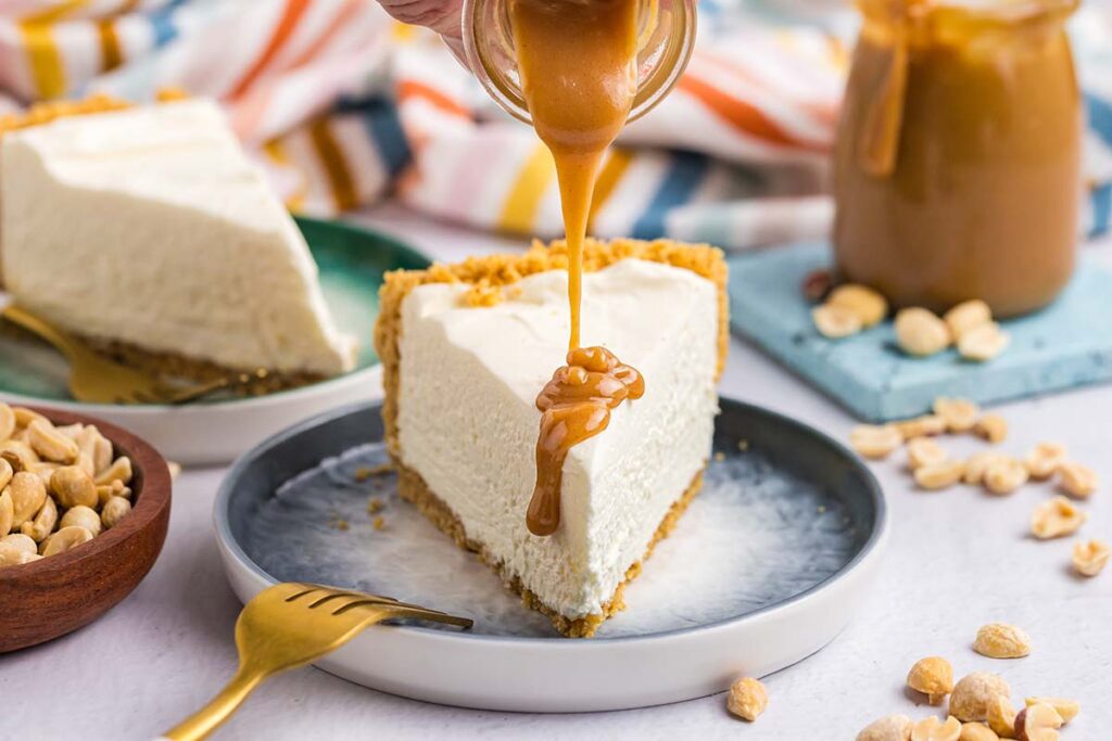 sauce poured onto slice of cheesecake